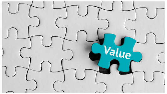 A close-up of a white jigsaw puzzle with one missing piece labeled ‘Value,’ symbolizing the focus on delivering customer value