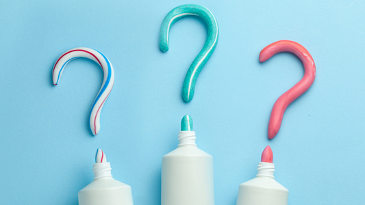 Three tubes of toothpaste with contents squeezed out into shape of question marks